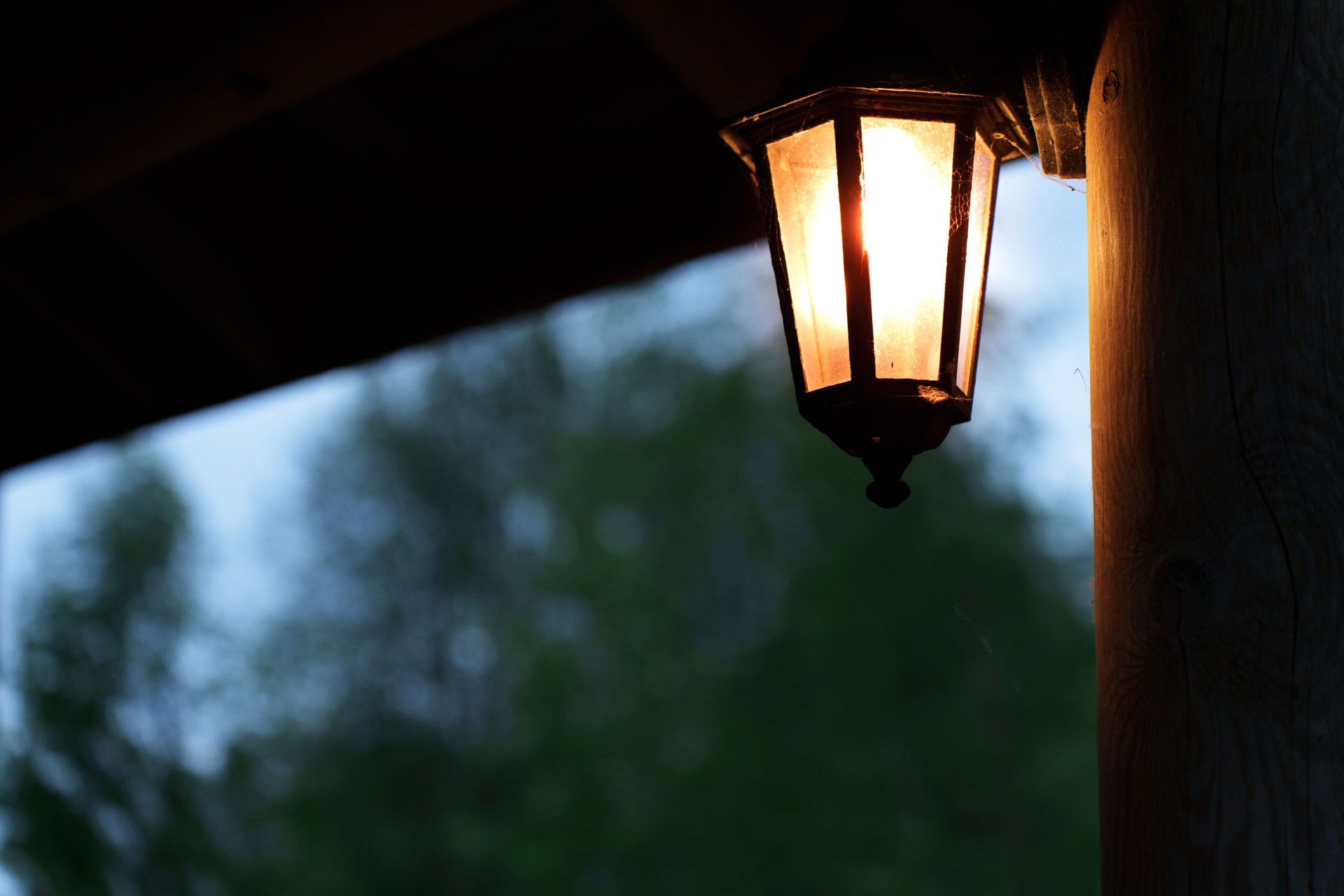 Porch light illuminating cozy summer evening.
